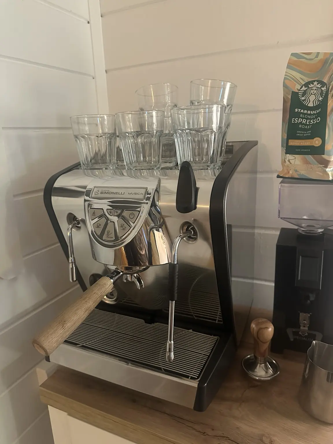 Nuova Simonelli Musica espresso machine with wood-handled portafilter in the Brew Uncut summer-house setup