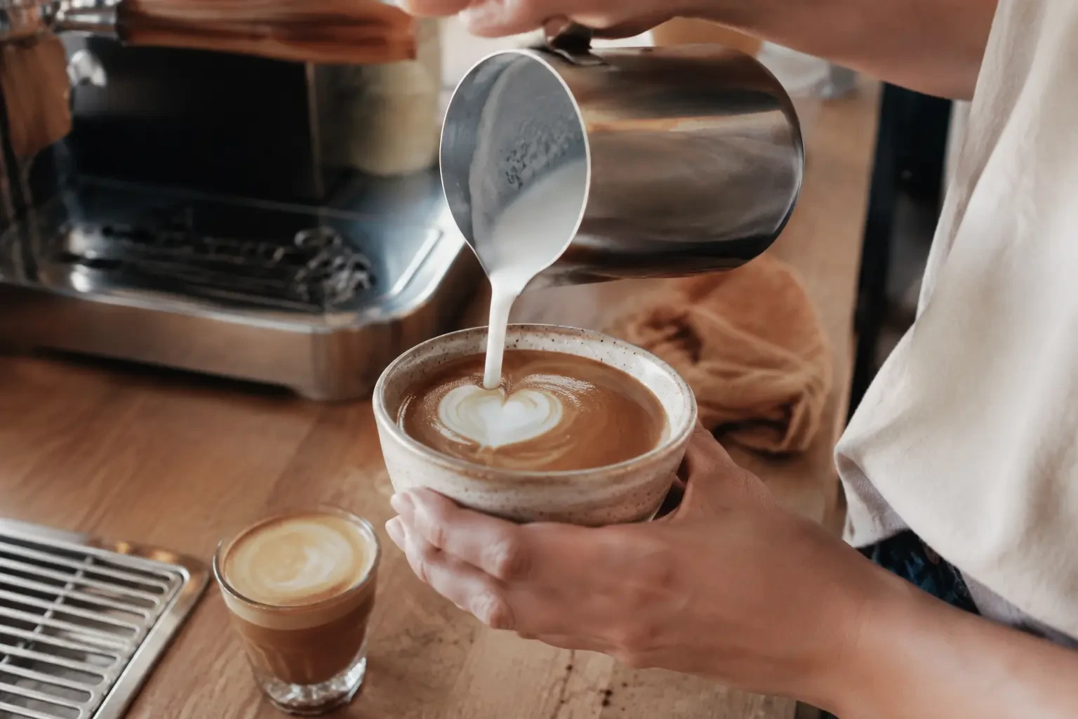 Milk being poured into espresso for latte art